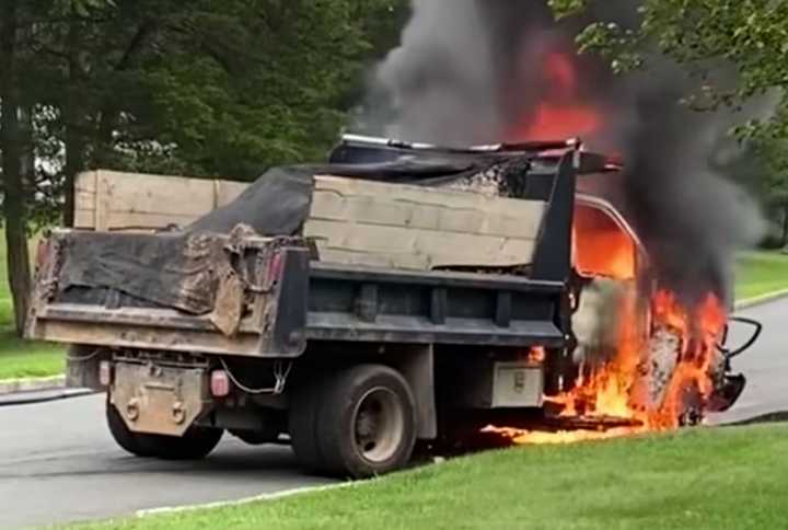 Emergency crews battled a mason dump that went up in flames at a Sussex County intersection.