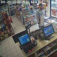 <p>Security footage from the Dash In convenience store. Brink is in front of the counter. Civilians’ faces have been blurred for privacy</p>