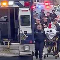 <p>The wounded suspect is brought to a waiting ambulance after the shooting during a DEA operation in Fort Lee on Tuesday, Jan. 10.</p>