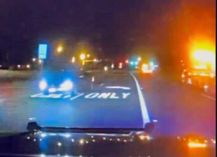 Police dashcam video shows a drunk driver in a BMW headed the wrong way on a highway at a police car.