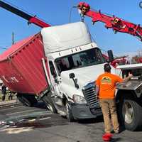 <p>The tractor-trailer is being uprighted.</p>