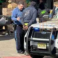 <p>Lakewood police take delivery truck driver Christopher Borker into custody. (Photo courtesy of The Lakewood Scoop)</p>