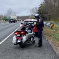 <p>A FCPD motor officer issues a citation on the Fairfax County Parkway.</p>