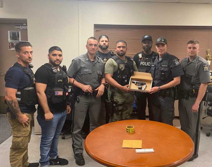 The Mount Vernon Police Department&#x27;s Violent Crimes Unit is pictured with the illegally-possessed firearm recovered from the pursuit.