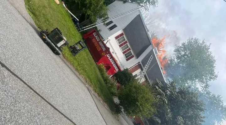 Flames ripped through the roof of a home on Willow Road in Milford on Monday, June 26