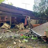 <p>Furniture is strewn about after a pickup smashed into a house in Howell.</p>