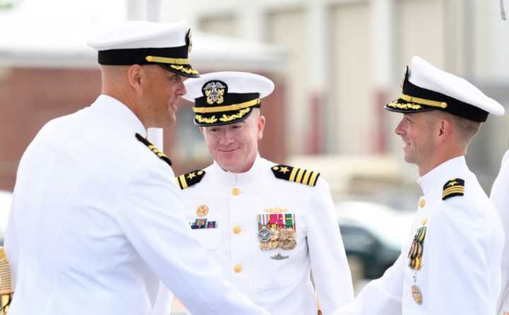 Cmdr. Scott Bresnahan, left, shakes hands with Cmdr. Kyle McVay after being relieved as commanding officer of the USS Indiana (SSN 789) during a change-of-command ceremony in Groton, CT, on June 23.