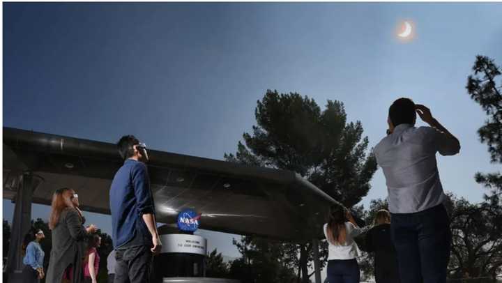 Employees and visitors at NASA's Jet Propulsion Laboratory stopped to watch the solar eclipse on Monday, Aug. 21, 2017.
  
