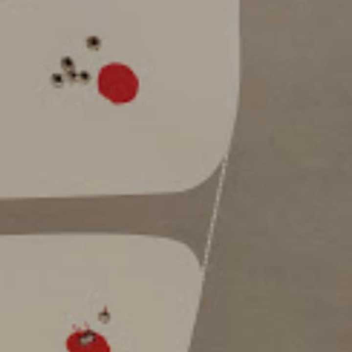 At the top of the photo: East Hartford Police Association President Frank Iacono said he used the Glocks issued to East Hartford police to try to hit the red dot. At the bottom: Iacono said he used a new gun to hit the target - with more success.