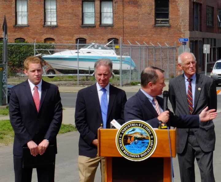 Back row from left to right: Holyoke Mayor Alex Morse, Congressman Richard Neal,  retired Congressman John Olver. At the podium is former Lt. Governor Timothy Murray.