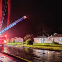 <p>In this photo, you can make out the part of the small aircraft planted in the roof of a Ring Drive home.</p>