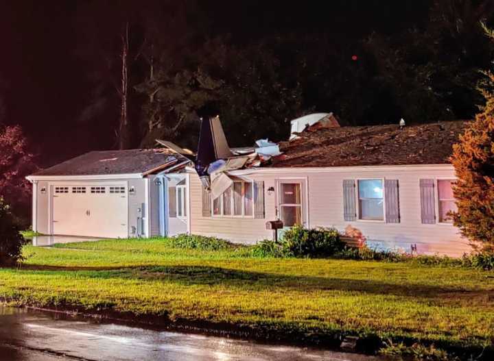 In this photo, you can make out the part of the small aircraft planted in the roof of a Ring Drive home.