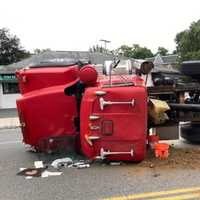 <p>An overturned dump truck has spread landscaper’s debris all over a city Avenue just in time for the Wed., Sept. 9 commute.</p>