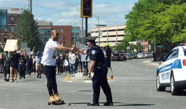 In this photo, a Worcester Police officer fist-bumps a man on a skateboard during a protest. More complaints were filed against Worcester Police officers last year than 2018. Still, it was fewer complaints than normal.