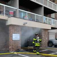 <p>Firefighters at a smoky blaze Sept. 30.</p>