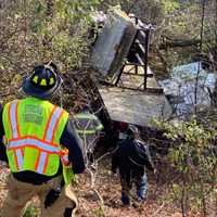 <p>Emergency responders at a flat-bed rollover on I-190 Monday, Oct. 19.</p>