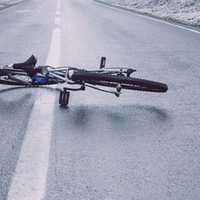 <p>A bicycle in the middle of the road.</p>