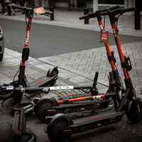 <p>Four scooters in a row with one knocked down.</p>