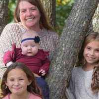 <p>Kim Fairbanks holds a baby in this undated family portrait with her granddaughters Aubrianna Lynn, 10, (bottom) and 12-year-old Michele.</p>