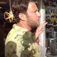 <p>Dragon Pizza owner Charlie Redd, right, argues with Barstool Sports President Dave Portnoy during a viral "One Bite Pizza Review" last year.&nbsp;</p>