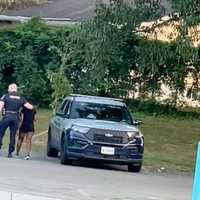 <p>The officer bringing the female to the back of the vehicle.</p>