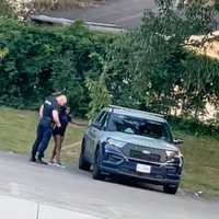 <p>The officer bringing the female to the back of the vehicle.</p>