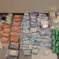 <p>Police said they found guns, money, and more than 200 pounds of drugs in four locations in Lynn.</p>