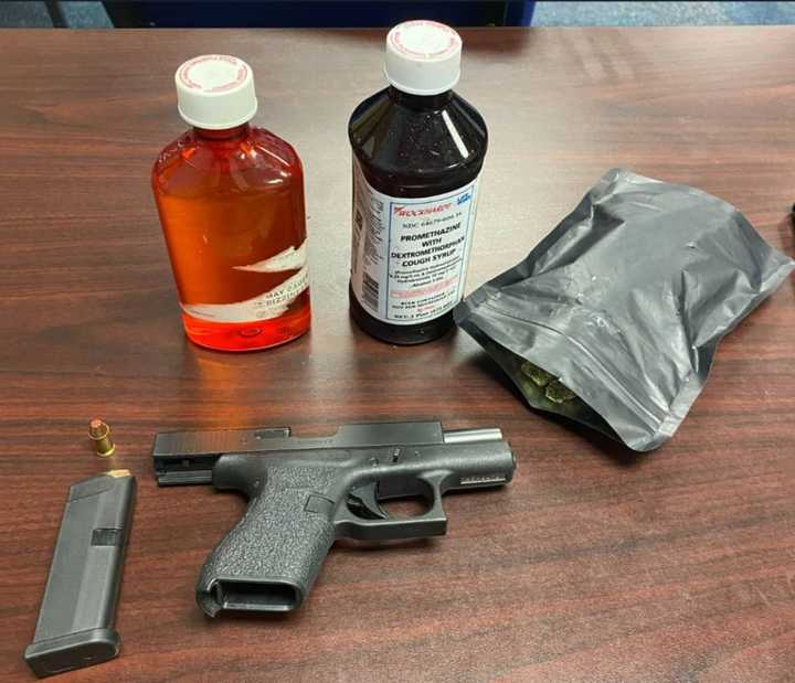 Loaded .38 caliber Glock handgun and two bottles of suspected promethazine/codeine recovered at the scene