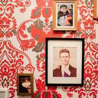 <p>Buzz McCallister on a wall of family photos.</p>