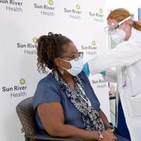 <p>Sun River Health RN and Health Center Director Sharon Andrades receiving the COVID-19 vaccine from Chief Nursing Officer Roberta Kelly, NP.</p>