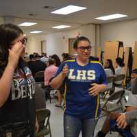 <p>Lyndhurst High School junior Nicole Bruno, sophomore Laura Lehman and senior Sarah Almeida sign to each other</p>