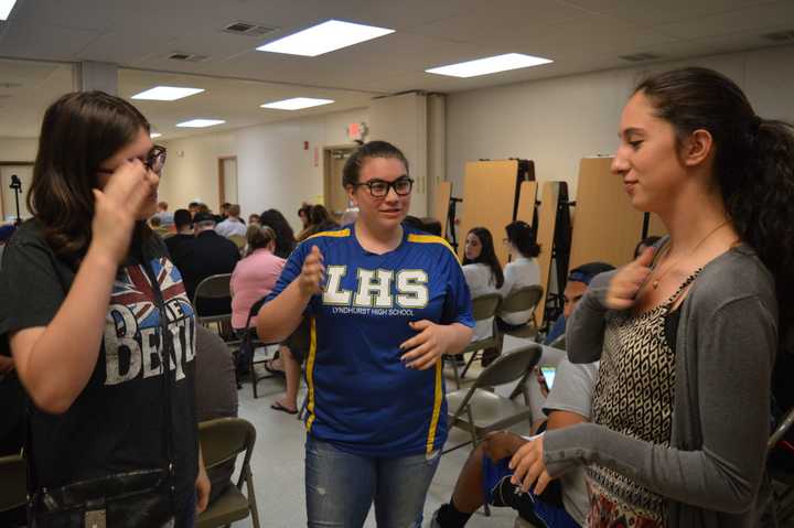 Lyndhurst High School junior Nicole Bruno, sophomore Laura Lehman and senior Sarah Almeida sign to each other