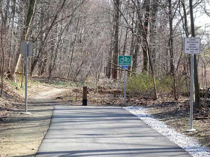 The paved portion of the South County Trailway meets a dirt path in Elmsford&#x27;s Van Cortlandt Park. The county recently got the final go-ahead to hire a contractor to close a gap in the trail in Greenburgh.