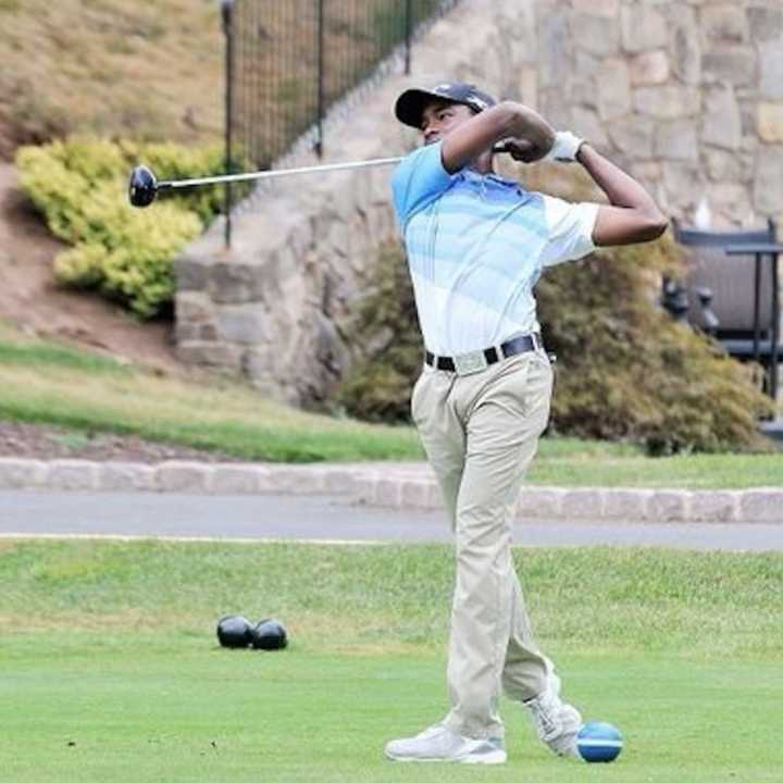 Laurent Span takes a swing on the green.