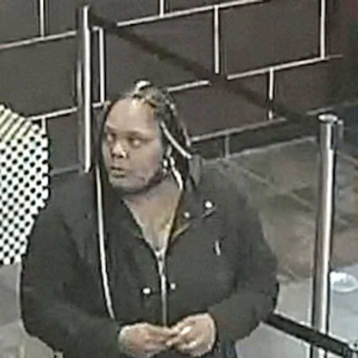 This woman is at large after punching a Long Island restaurant employee, police say.