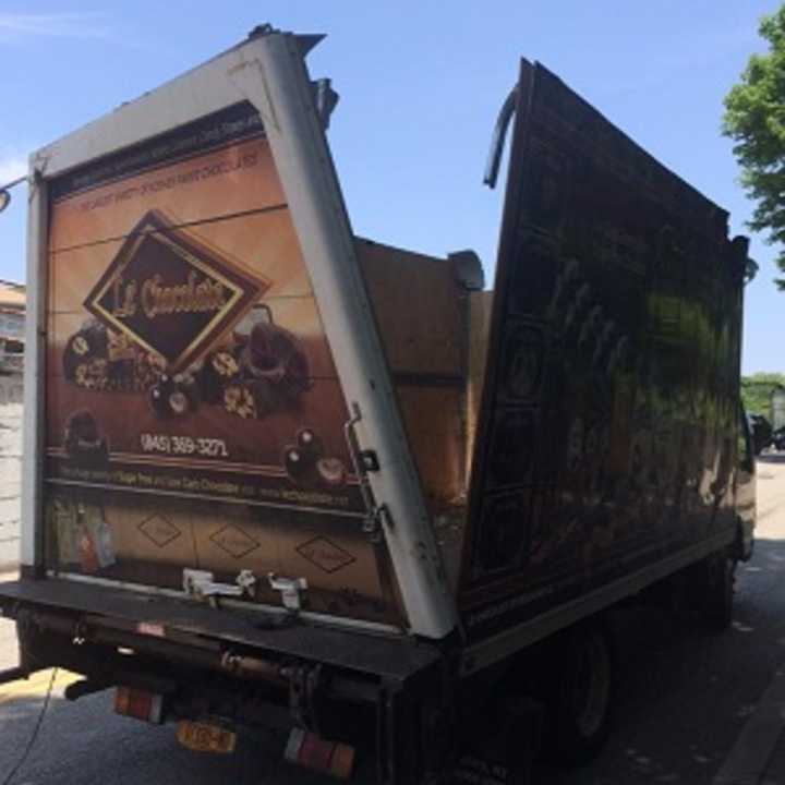 A box truck was split open and its roof torn off Wednesday after it hit a ledge on the Chestnut Street bridge in Suffern.