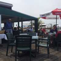 <p>A shaded awning area extends from the inside restaurant to the deck at Sunset Grill in Norwalk.</p>