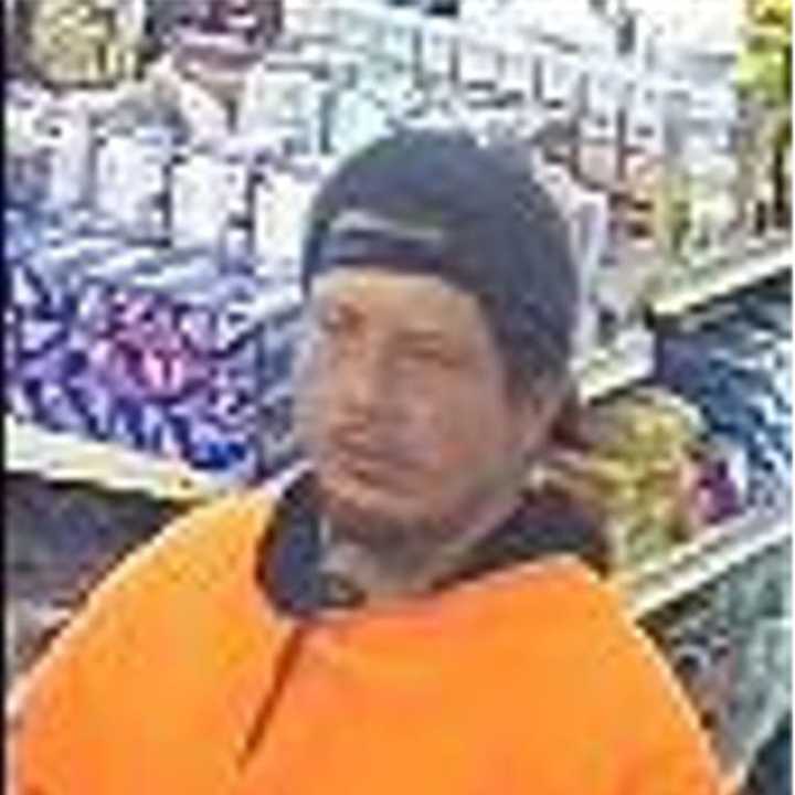 Police are searching for a man accused of stealing an envelope containing $1,200 at a Long Island deli in April.