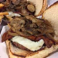 <p>You can barely see the burger for all the sauteed mushrooms, onions, bacon and Swiss cheese piled on top at TFS Burger Works in West Haverstraw.</p>