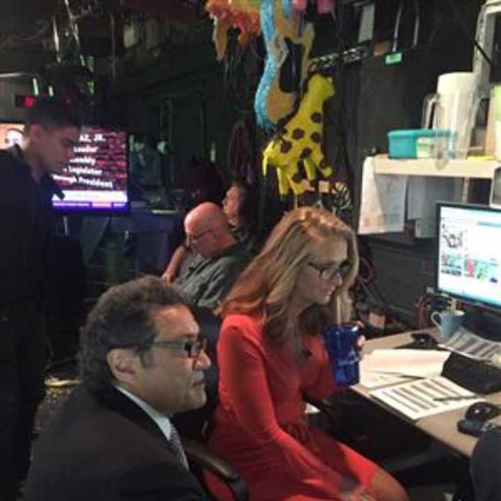 Principal Tom Stella prepares for the weather forecast with WPIX meteorologist Linda Church.