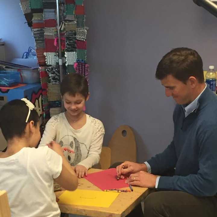 Giants quarterback Eli Manning visits with childhood cancer patients at Hackensack University Medical Center.