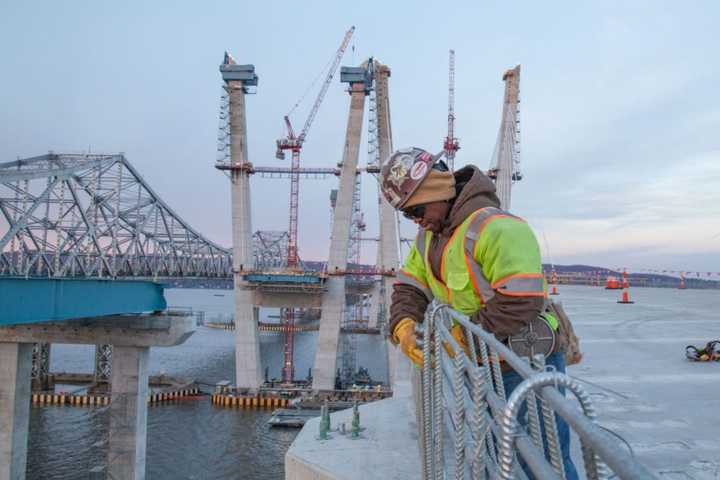 An ironworker ties steel reinforcement for a concrete barrier on the new Tappan Zee Bridge.