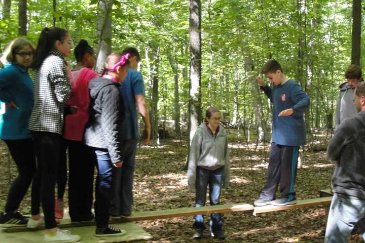 Irvington Seventh-Graders Work Together Through Obstacle Course Challenges 
