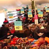 <p>Shoppers crowd the tent at last year&#x27;s sale at Dooney &amp; Bourke in Norwalk.</p>