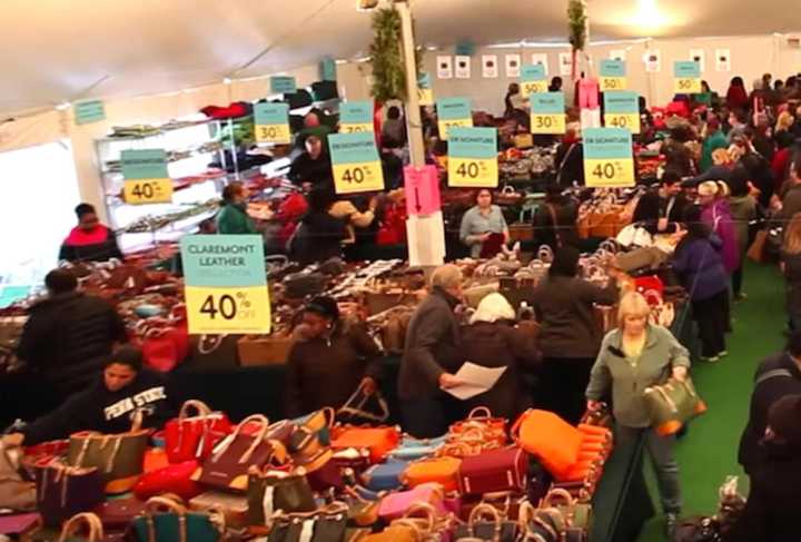 Shoppers crowd the tent at last year&#x27;s sale at Dooney &amp; Bourke in Norwalk.