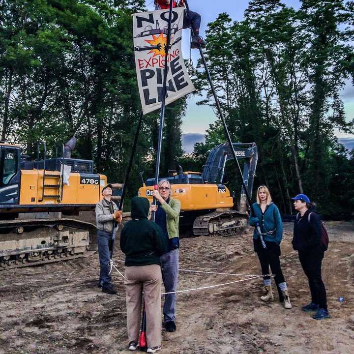 A protester climbed up a 20-foot tripod to oppose construction of the Spectra pipeline.