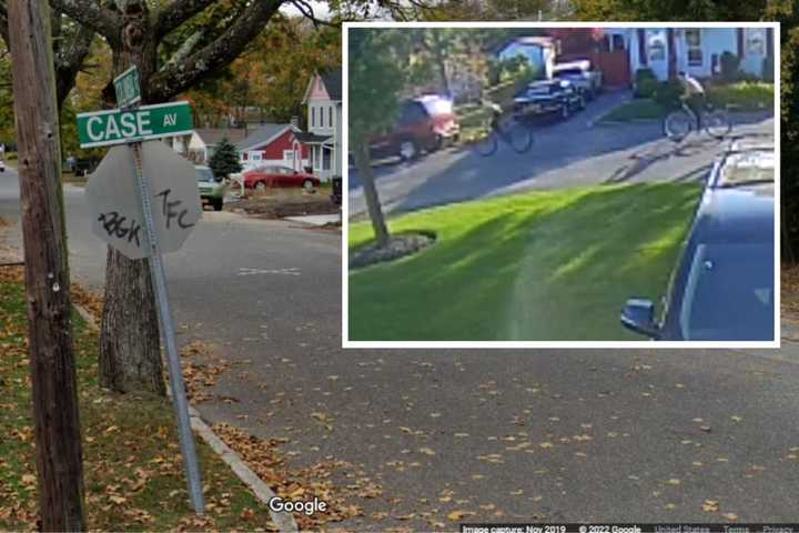 Suffolk County Police need help identifying two people seen damaging a Pride flag at a home on Case Avenue in Patchogue in May 2022.