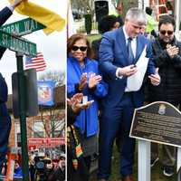 <p>Malverne Mayor Keith Corbett unveils the newly renamed Acorn Way during a ceremony held outside Maurice Downing Elementary School on Thursday, Jan. 26.</p>