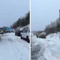 <p>Authorities clean up a fuel spill resulting from a tractor-trailer crash on I-84 in Willington.</p>