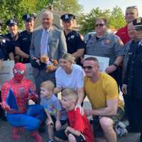 <p>Shane Petruzzelli and his family seen with Nassau County Executive Bruce Blakeman and members of the Nassau County Police Department during a homecoming ceremony in Oceanside on Thursday, May 11.</p>